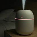 LED car air humidifier diffuser with aromatherapy mist, 220ml capacity, USB-powered in pink, green, and white.