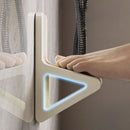 Hand holding a modern shower head against a neutral background