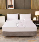 
A "Waterproof Mattress Protector" on bed showing water drops