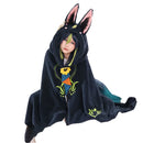 Wearable anime cosplay hooded blanket with printed cartoon design draped over sofa.