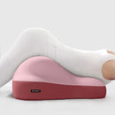 Memory foam hip pillow for couples on bed, used for sitting, lying, or pregnancy support.