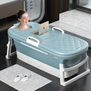 Foldable adult plastic bathtub with thickened design set up in a modern bathroom.