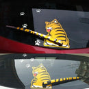 Cartoon tiger decal on a car's rear window with paw prints.