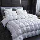 Luxury white goose down comforter with thick pinch pleats on a modern bed setting.