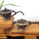 Antique-style metal lotus incense burner bowl with handle, ideal for meditation and home decor.