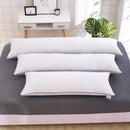 White long body pillow core placed on a neatly made bed, showing plush softness and rectangular shape, ideal for decorative or sleep use.