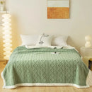 "Thick tapestry-style lamb wool blanket made of polyester, folded on a sofa, showcasing its warm, textured weave and elegant design, ideal for naps, office use, or home decor."